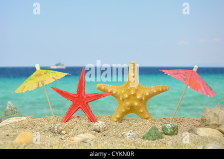 Summer scene #18 - Two star fishes with paper umbrellas Stock Photo
