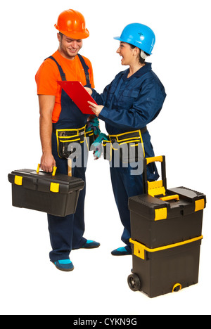 Cheerful builders workers team having conversation and looking on a clipboard isolated on white background Stock Photo