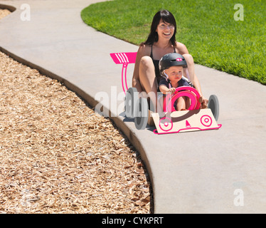 Mother and son driving go kart Stock Photo