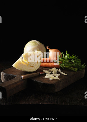 Onion, carrot and cabbage on board Stock Photo