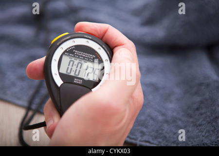 Close up of hand holding stopwatch Stock Photo