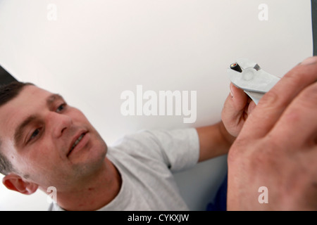 Worker stripping a wire with cutters Stock Photo