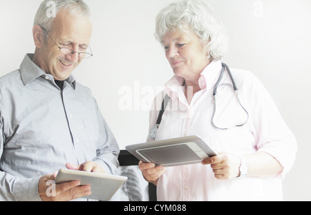 Doctors using tablet computers Stock Photo