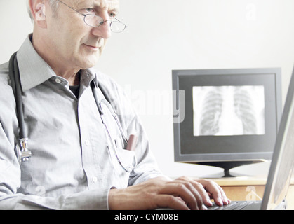 Doctor using laptop in office Stock Photo
