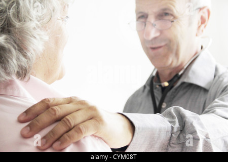 Doctor with hand on patient’s shoulder Stock Photo