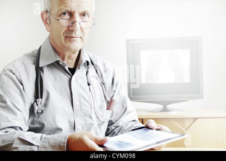 Doctor using tablet computer in office Stock Photo