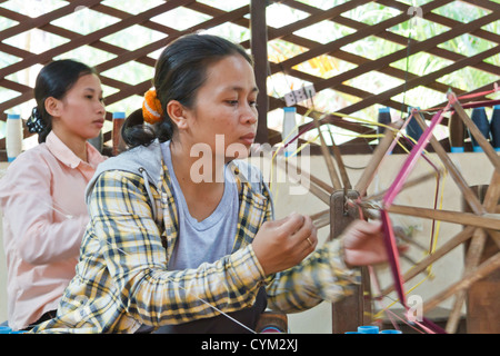 Spinning traditional Cambodian Silk at the Artisans d'Angkor near Siem Reap, Cambodia Stock Photo