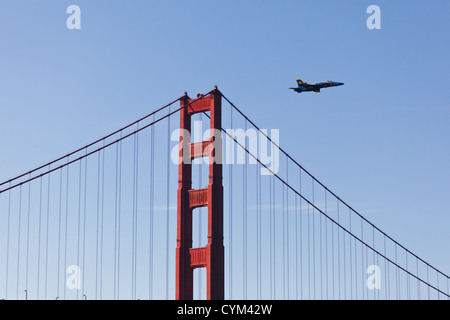 Fighter jet flies low over Golden Gate Bridge during Fleet Week Air show on in SAN FRANCISCO, CALIFORNIA, USA. Stock Photo