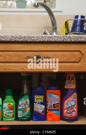 Kitchen and household cleaning products sitting on a shelf in a Kitchen cupboard. Stock Photo