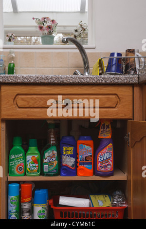 Kitchen and household cleaning products sitting on a shelf in a Kitchen cupboard. Stock Photo