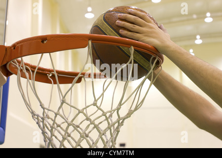 scoring basket in basketball court Stock Photo