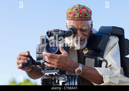 African American man using film camera Stock Photo