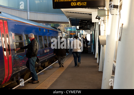 Commuters and passengers boarding a train at Newport railway station. Stock Photo