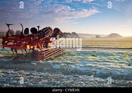 Frosty autumnal sunrise over Wiltshire countryside landscape with iconic neolithic Silbury Hill in the distance Stock Photo
