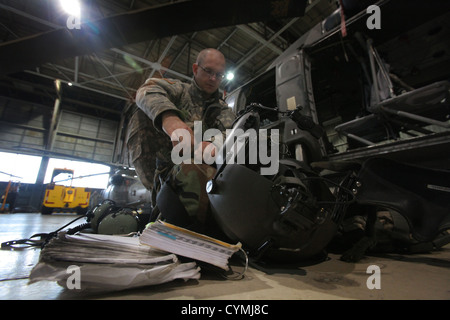 A New Jersey Army National Guard crew chief with the 1-150th Assault Helicopter Battalion prepares for another search and rescue mission following the passing of Hurricane Sandy Oct. 30, 2012. (U.S. Air Force photo by Master Sgt. Mark C. Olsen/Released) Stock Photo