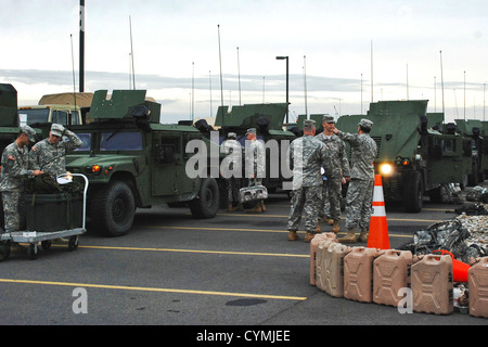 New York Army National Guard soldiers assigned to the 206th Military Police Company prepare to move out on a road march from New York State Division of Military and Naval Affairs Headquarters here to the Farmingdale Armed Forces Reserve Center as part of the New York state response to Hurricane Sandy on Sunday, Oct. 28. The soldiers are among more than 1,100 Army and Air National Guard soldiers and airmen deployed at the order of New York Gov. Andrew M. Cuomo to respond to the storm. Stock Photo