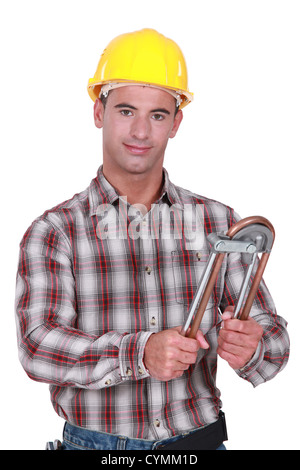 Tradesman using a tube bender Stock Photo