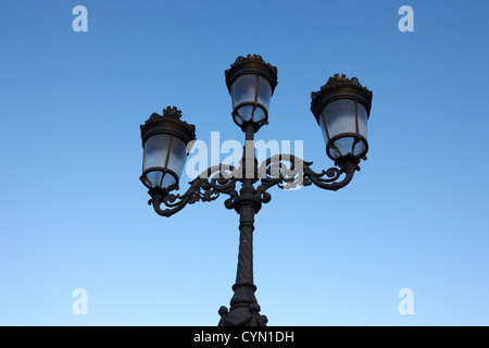 victorian three armed column street lighting originally gas now electric on oconnell bridge dublin republic of ireland Stock Photo