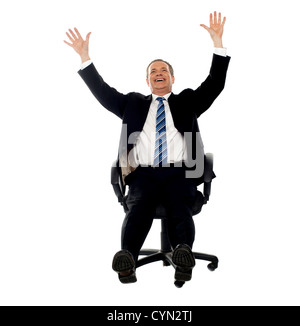 Excited businessman celebrating success with his arms raised up ...