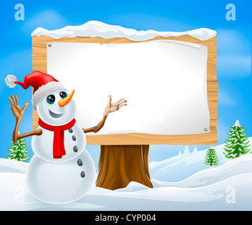 Christmas snowman with Santa hat in snowy landscape with sign Stock Photo
