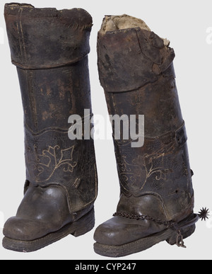 A pair of cuirassier's boots,Lyon,2nd half of the 17th century. Heavy boots made of thick leather,the front with embroidered decoration and carved,hardly legible maker's name 'DUSSADSSOY LEOADET BOTTIER A LYON'(?). Knee covers with old linen padding. Lateral loops for fastening the boots to the saddle are missing. One boot with matching iron spur. Height ca. 59 cm(each). Rare impactproof and cutproof boots worn by cuirassiers in battle as a part of their leg armour,historic,historical,,17th century,defensive arms,weapons,arms,weapon,arm,fighting d,Additional-Rights-Clearences-Not Available