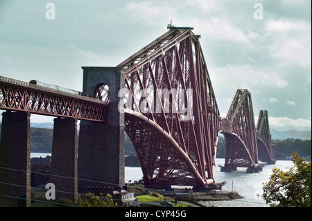 A ScotRail train crossing the 2.5 km ( 1.5 mile) long newly painted Cantilever Forth Railway Bridge Stock Photo