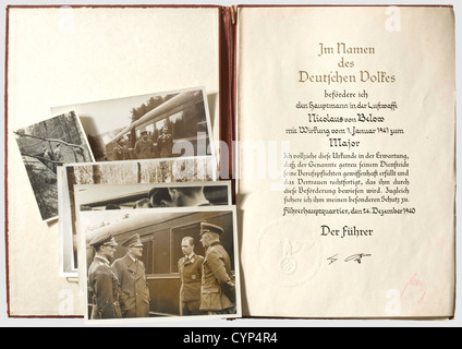 Oberst Nicolaus Freiherr von Below(1907 - 983)- a certificate of promotion to major,in a leather folder.Large,double-page document with printed/calligraphic text dated 24 December 1940 and blind-stamped seal(the swastika with minimal damage).Ink signatures of Adolf Hitler and Hermann Göring in red indelible pencil.The exterior of the red-brown leather folder with gold-stamped eagle(slightly bumped,somewhat damaged on the inside).The interior lined with paper(slightly foxed).Dimensions 36.5 x 26 cm.With ten Hoffmann press photos(slightly damaged),,Additional-Rights-Clearences-Not Available Stock Photo
