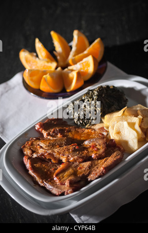 Real food photographed on location in traditional portuguese restaurants, pork fillet seasoned with red bell pepper Stock Photo