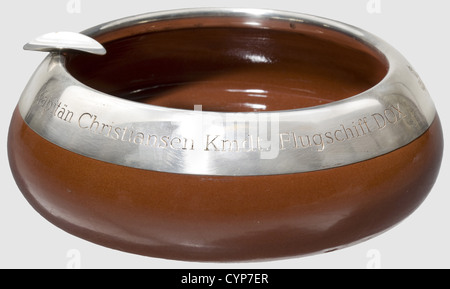 Friedrich Christiansen,the most successful naval aviator in World War I - a gift ashtray from Kaiser Wilhelm II 1931,Imperial Majolika Manufactory Cadinen,red-brown glazed stoneware,the base with the impressed manufactory mark. Silver mounting with hallmark '925' and surrounding dedication engraving 'Captain Christiansen Commander Airship DO X - Christmas 1931'(transl.)and the crowned cipher 'WH' of Kaiser Wilhelm and his wife Hermine. Diameter 19 cm,historic,historical,1930s,20th century,troop,troops,armed forces,military,militaria,army,wing,,Additional-Rights-Clearences-Not Available Stock Photo