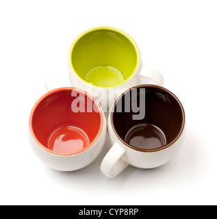 Three color coffee cups, above view, isolated on white background Stock Photo