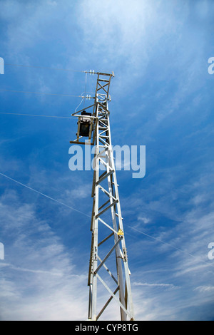 electricity tower with the blue sky behind Stock Photo - Alamy