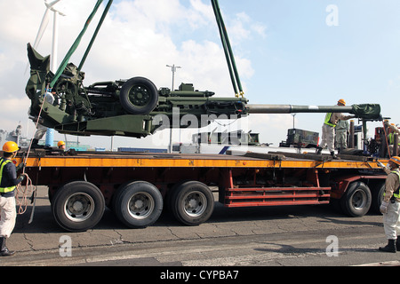 An M777A2 155 mm howitzer is loaded onto a trailer Nov. 7 at Yokohoma Port, Tokyo. Howitzers and other equipment were transported from the port to Combined Arms Training Center Camp Fuji for use during Artillery Relocation Training Program 12-3. Stock Photo