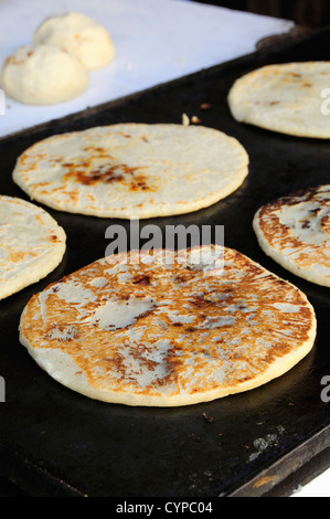 Nutritious handmade corn tortilla cooked on a metal griddle on a gas stove  in a Guatemalan home Stock Photo - Alamy