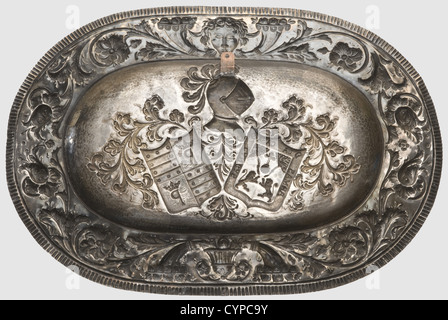 Hermann Göring,an elaborate silver dish,a present from a Spanish nobleman Hand-hammered silver decorated in high relief.Oval form,the border decorated with blossoms,scrolling foliage,cornucopiae,and mascarons.The centre shows the combined coat of arms of the Cangas family of Asturias and a coat of arms bearing the colours of the Valdés family in the second and third quarter of the shield.Master's mark 'S.Gonzalez' and Spanish hallmarks.Ca.63 x 43 cm,weight 1498 g.Provenance: 'Freiwillige Versteigerung aus dem ehemaligen Besitz von Hermann Göring',,Additional-Rights-Clearences-Not Available Stock Photo