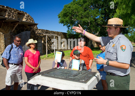 Park ranger informing tourists at the San Antonio Missions National Historical Park located in San Antonio, Texas, USA. Stock Photo