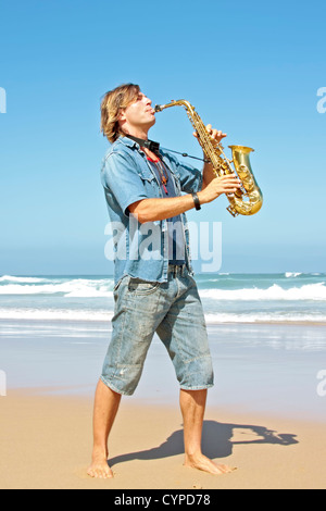 Professional saxophone player at the beach Stock Photo