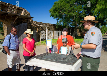 Park ranger informing tourists at the San Antonio Missions National Historical Park located in San Antonio, Texas, USA. Stock Photo