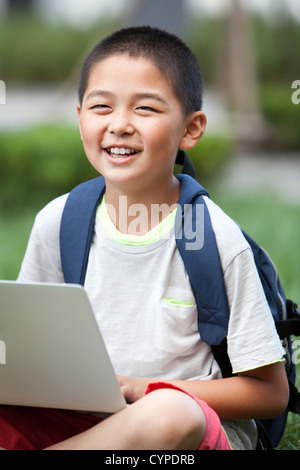 Happy schoolboy using high-tech laptop Stock Photo