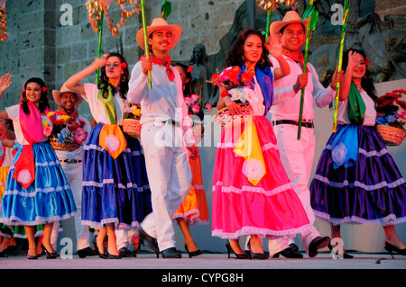 Plaza Tapatia Folkloric dancers from Guerrero State wearing brightly coloured costume performing at carnival  American Classic Stock Photo