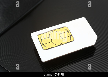 sim card on a black metal background Stock Photo