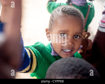 A young school girl at an orphanage in Usa River Village near Arusha poses for a photo. Stock Photo