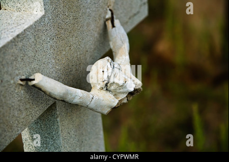 Broken figure of jesus Christ on a grave marker Stock Photo