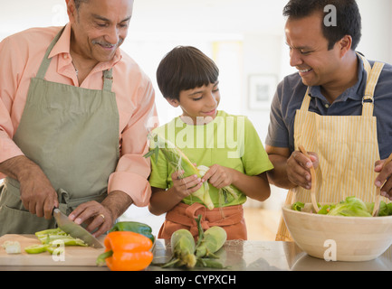 Hispanic grandfather, father and son preparing food Stock Photo