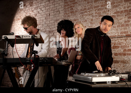 Cool performers at a disco party with admiring ladies Stock Photo