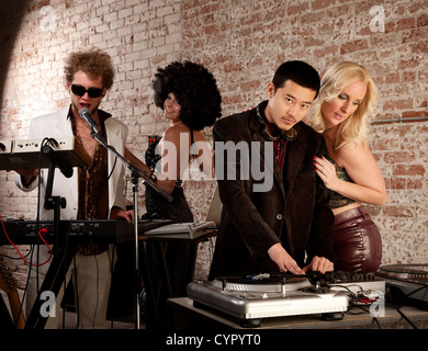 Cool performers at a disco party with admiring ladies Stock Photo