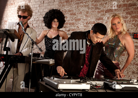 Cool performers at a disco party with admiring ladies Stock Photo