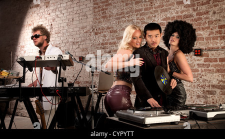 Mac Daddy DJ with Ladies at a 1970s Disco Music Party Stock Photo