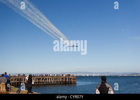 6 Fighter jets leave vapor trail as they fly over San Francisco Bay in precision delta wing formation in Fleet Week show Stock Photo