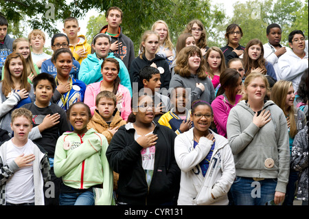 Multicultural group of Texas junior high school students recite Pledge of Allegiance during field trip to rural Milam County TX Stock Photo