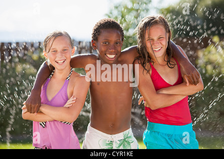 Friends playing in water Stock Photo